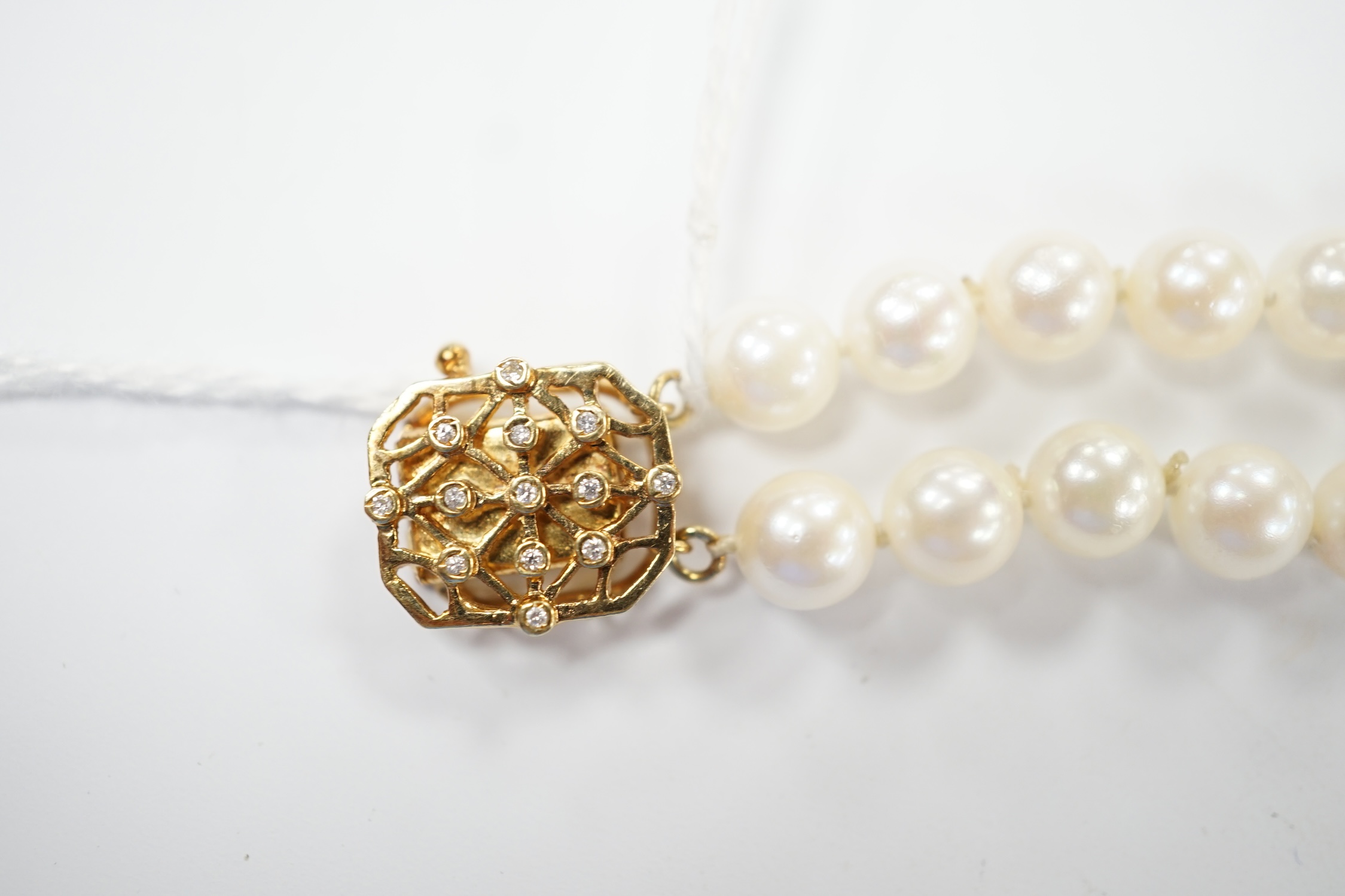 A double strand cultured pearl bracelet, with diamond chip set 14k clasp and spacers, 18cm. Condition - good